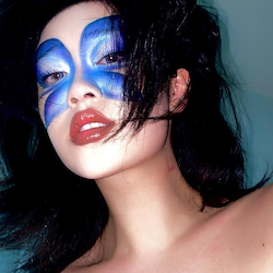 Funky Nutmeg with a blue butterfly painted on her face